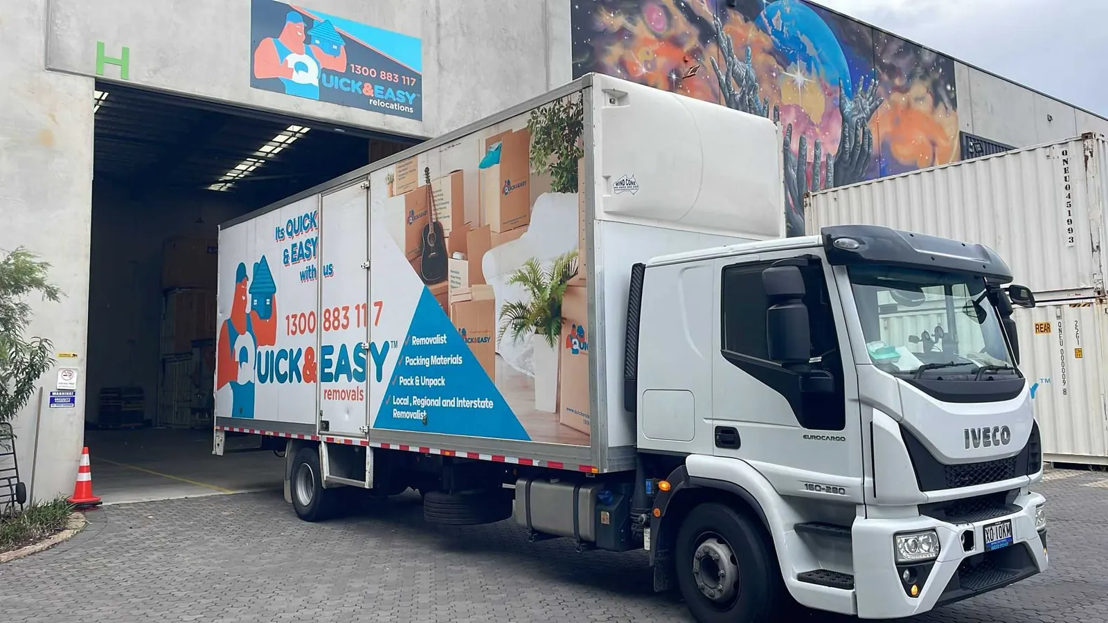 Quick and Easy removal truck parked at the company depot roller door in Sydney
