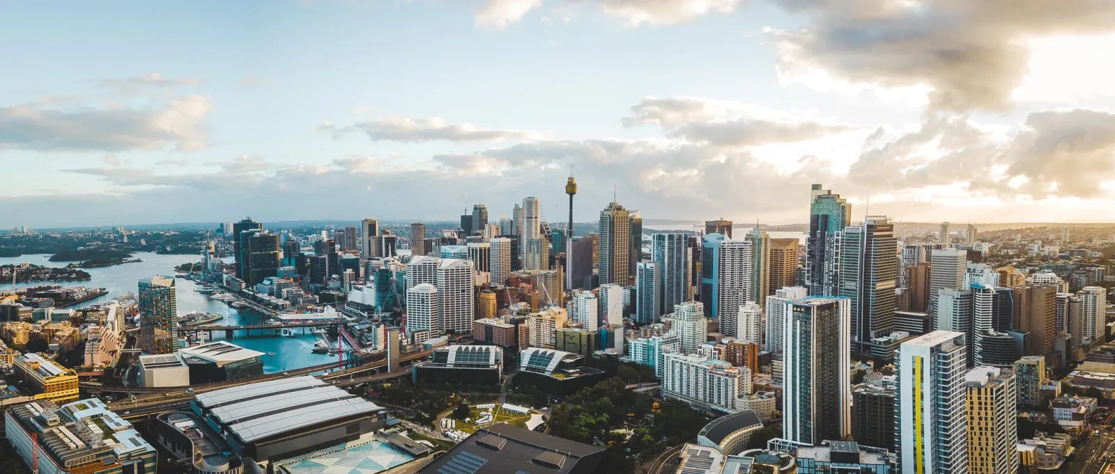 Aerial view of the Sydney CBD at golden hour with Sydney Tower and Darling Harbour in frame
